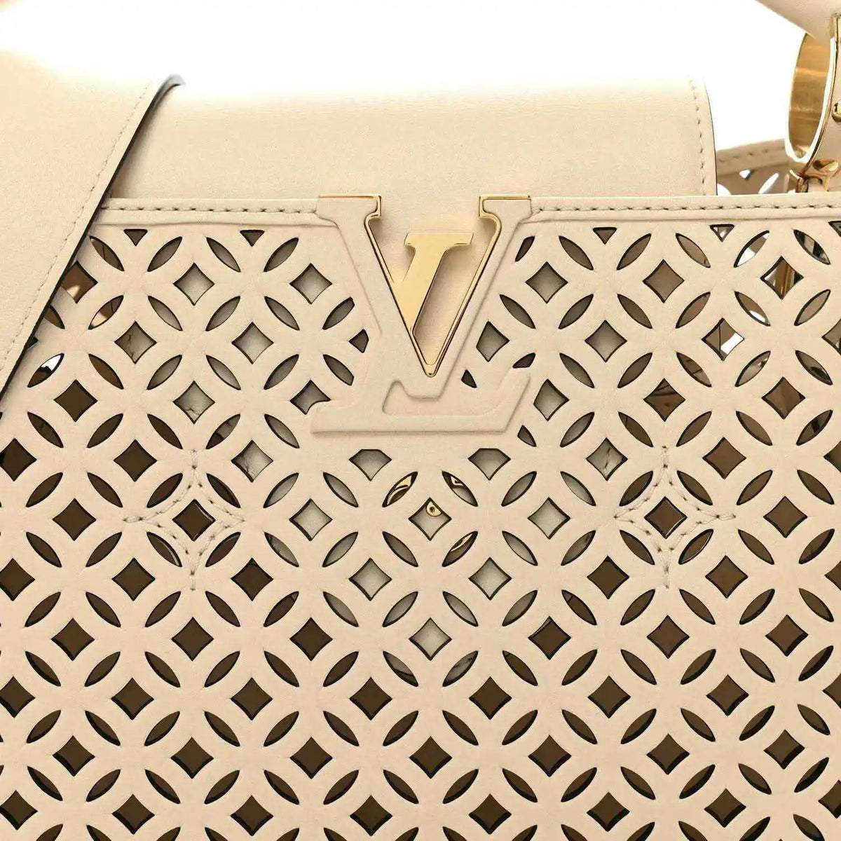 Louis Vuitton handbag front panel close-up with V detail and cut-out lattice pattern