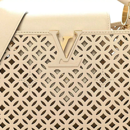 Louis Vuitton handbag front panel close-up with V detail and cut-out lattice pattern
