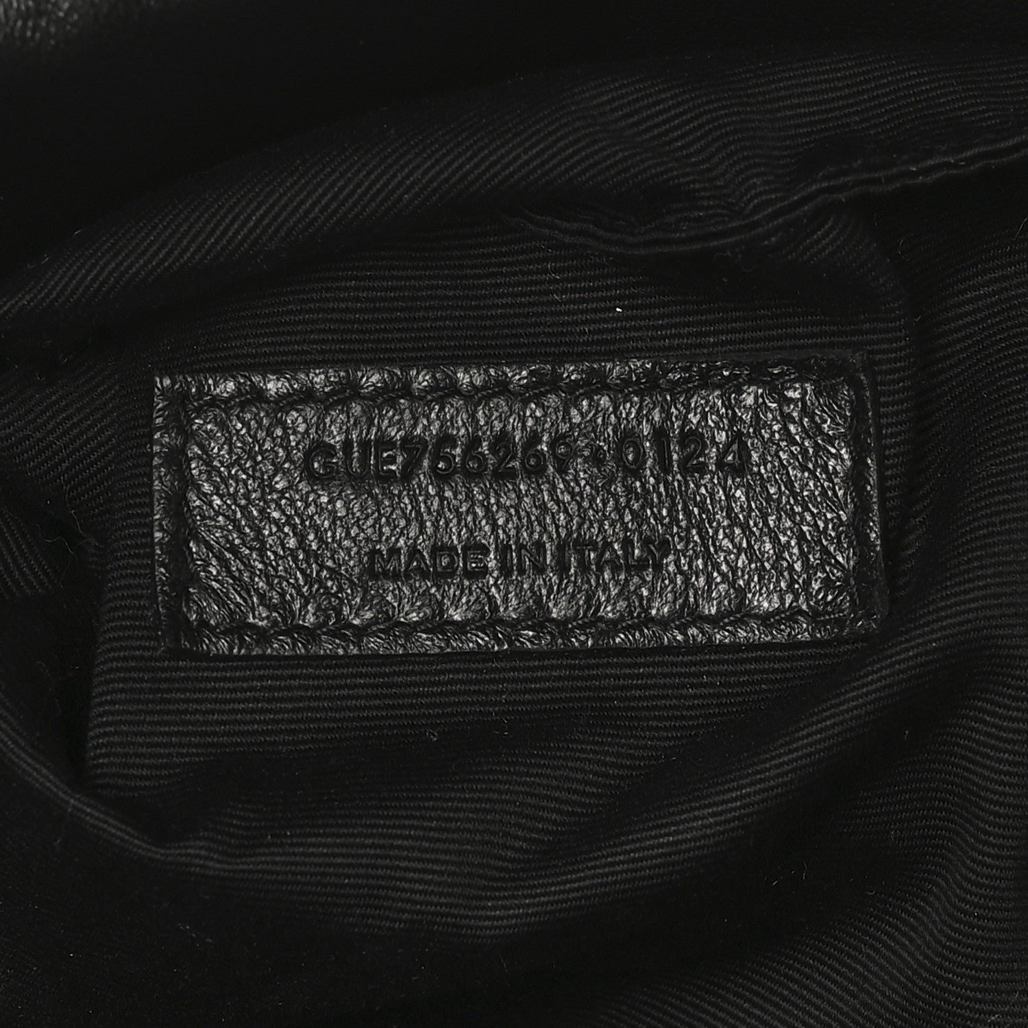 Black leather tote interior care label with model code and Made in Italy text.