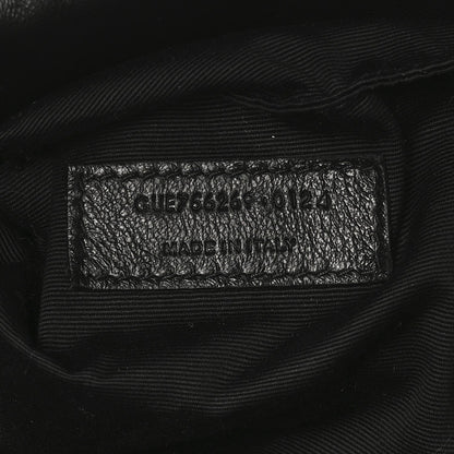 Black leather tote interior care label with model code and Made in Italy text.