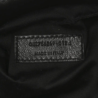 Black leather tote interior care label with model code and Made in Italy text.