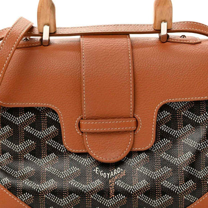 Mini Saigon bag front close-up, brown flap with patterned canvas panels and leather strap