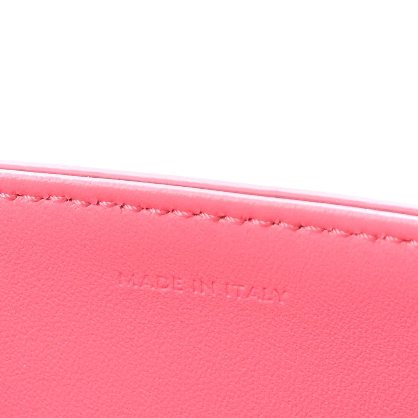 Flamingo pink leather with fine edge stitching along the top rim