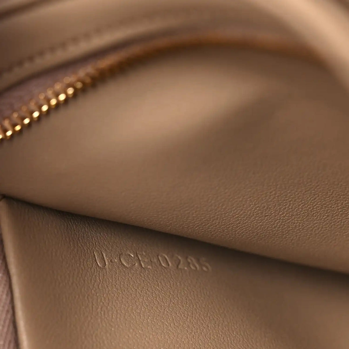 Close-up of embossed leather stamp on the bag interior