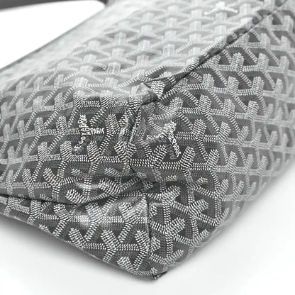 Grey coated canvas bag corner with repeating pattern and logo patch