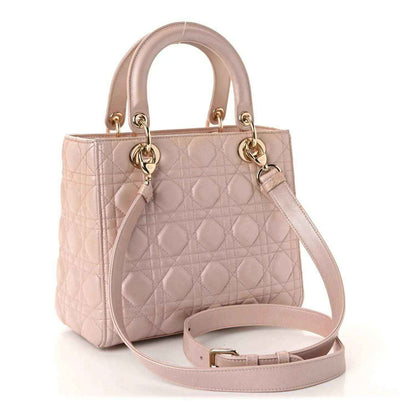 Light pink quilted handbag with two top handles and matching detachable crossbody strap
