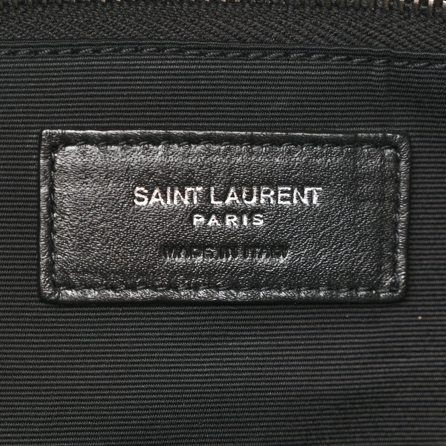 Saint Laurent Paris leather label on black satchel interior lining