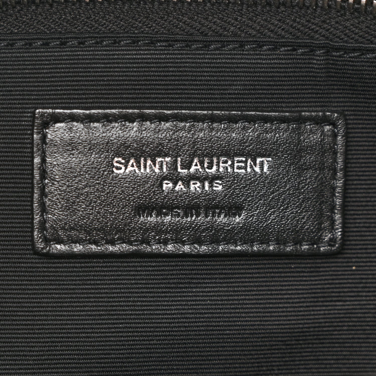 Saint Laurent Paris leather label on black satchel interior lining