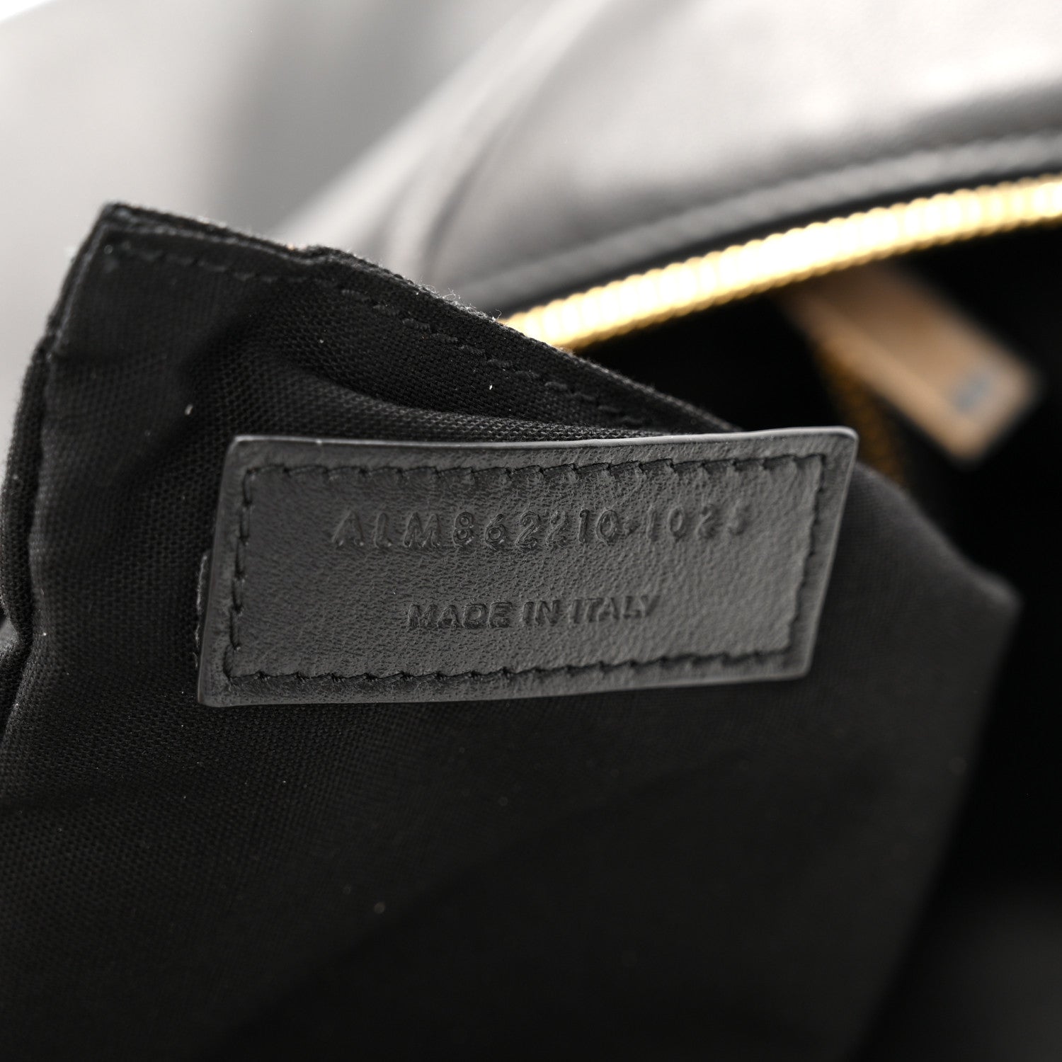 Made in Italy leather label on black hobo bag with gold zipper edge