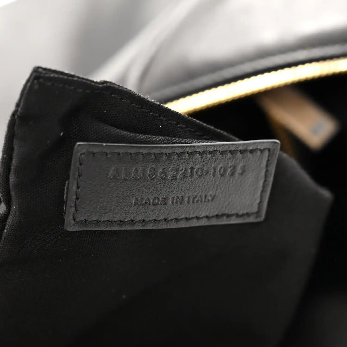 Made in Italy leather label on black hobo bag with gold zipper edge
