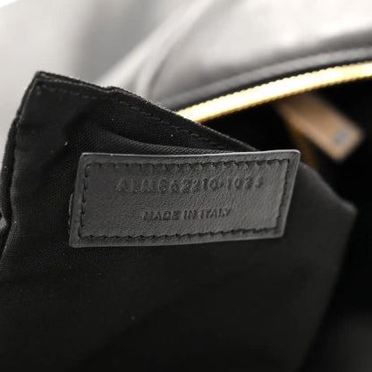 Made in Italy leather label on black hobo bag with gold zipper edge