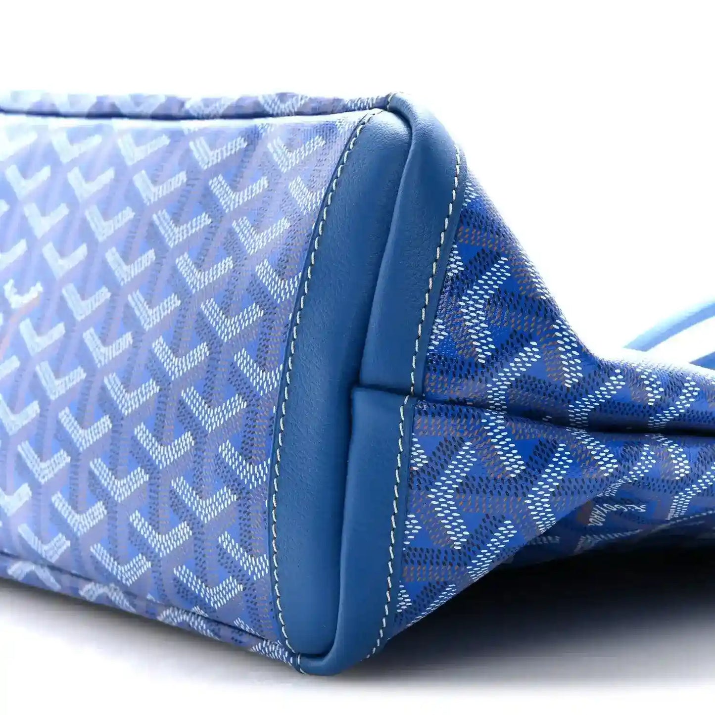 Close-up of sky blue tote bag side with leather piping and stitched panel join