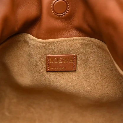 Loewe logo patch inside suede lining of Flamenco knot clutch