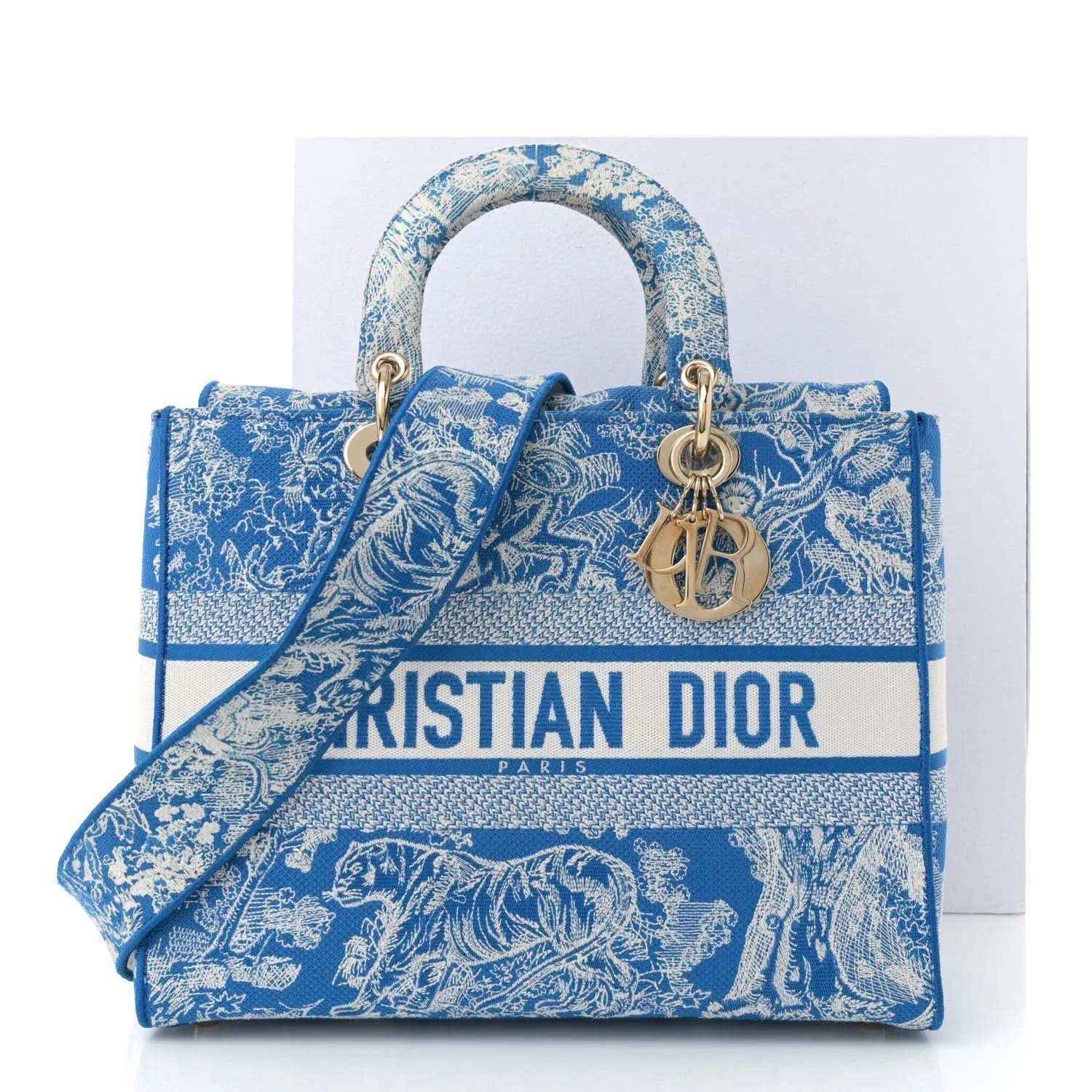 Blue toile embroidered tote bag with gold-tone handles and CD charm