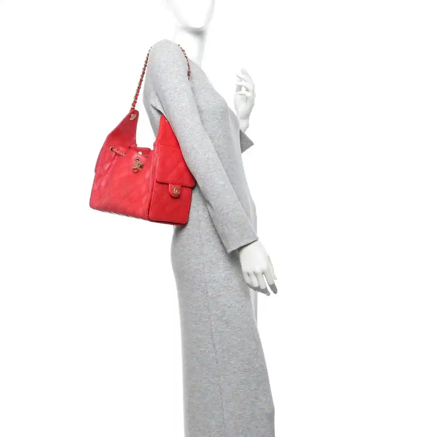 Quilted leather handbag worn over shoulder, burgundy with gold chain strap.