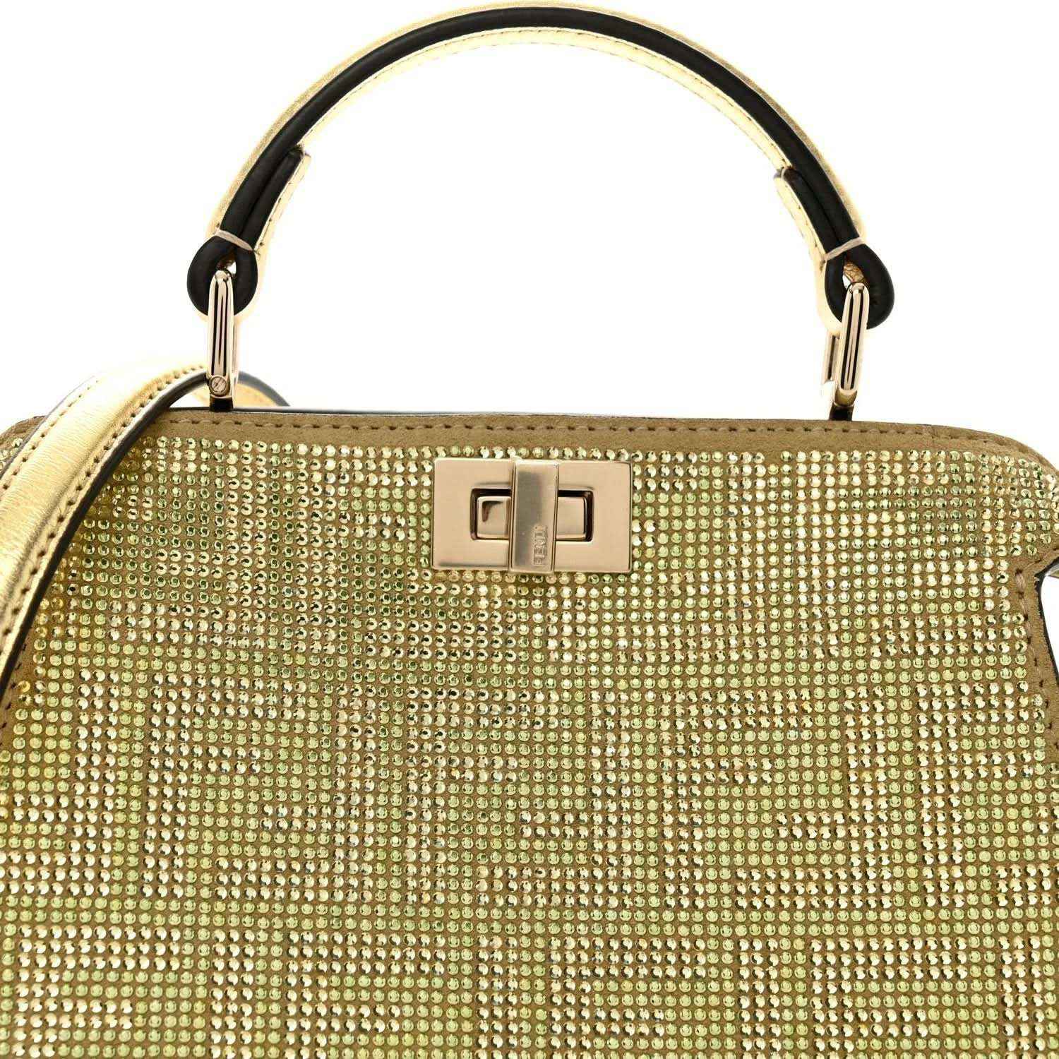Gold crystal top handle with rectangular clasp detail and metal rings