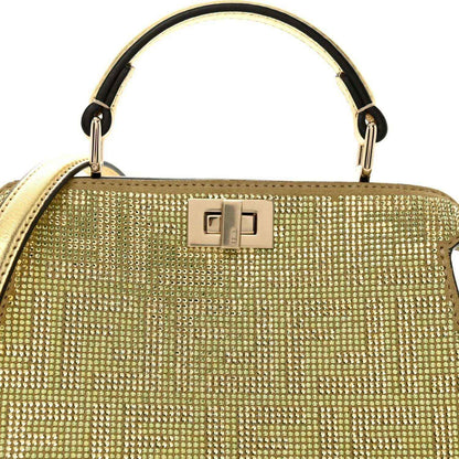 Gold crystal top handle with rectangular clasp detail and metal rings