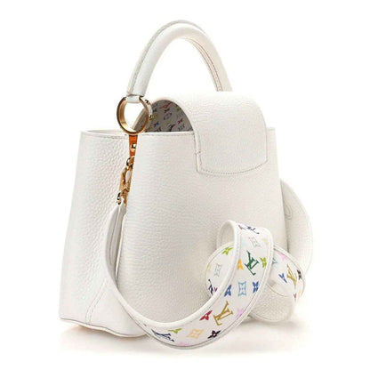 White leather handbag with structured body, gold-tone ring, and multicolor monogram strap