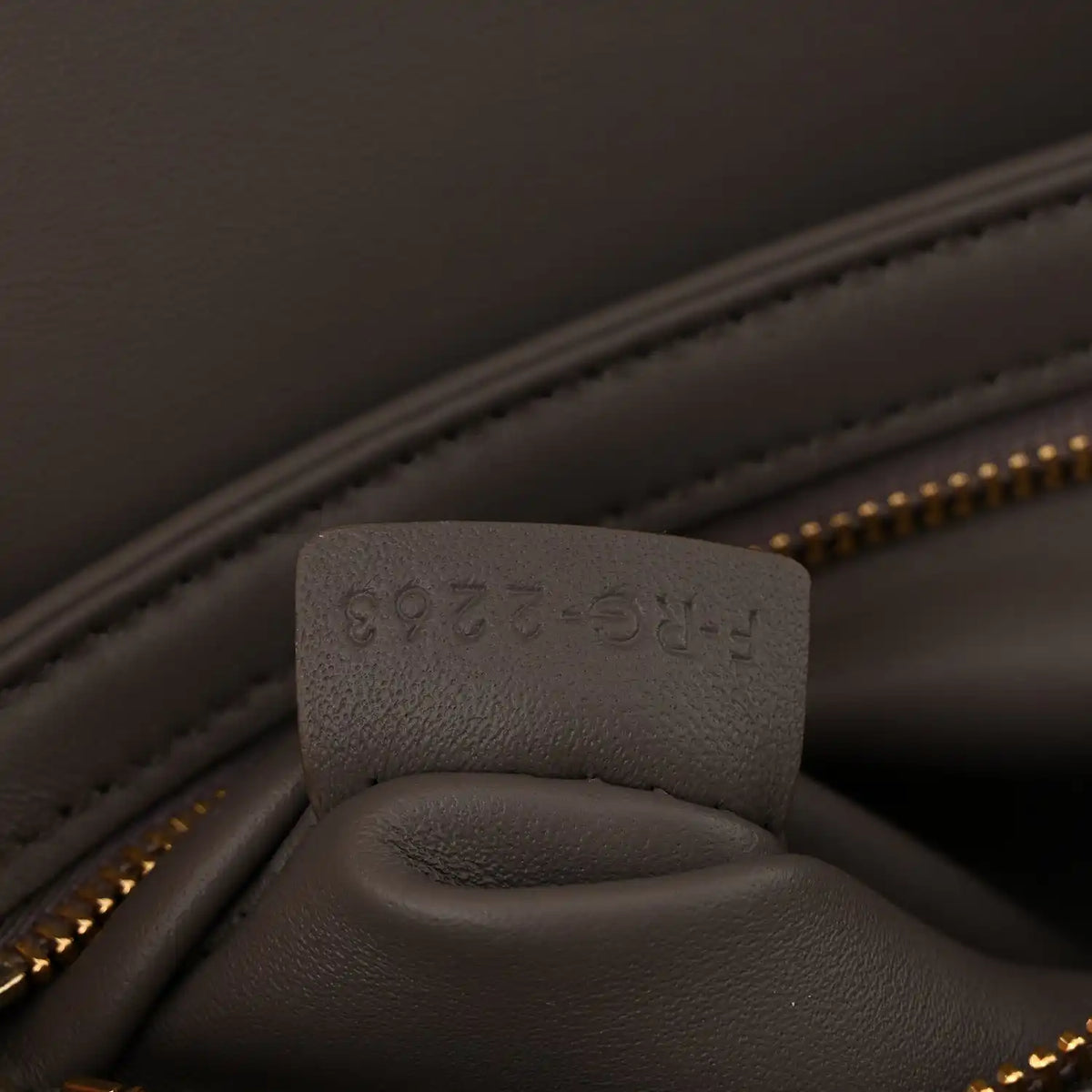 Close-up of interior pocket and stamped leather tab inside Celine bag