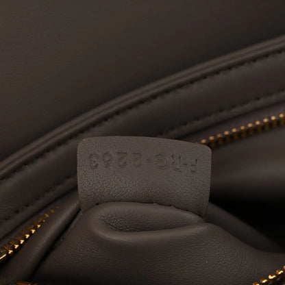Close-up of interior pocket and stamped leather tab inside Celine bag