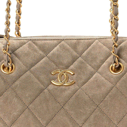 Chanel quilted suede bowling bag front with gold CC logo and chain straps