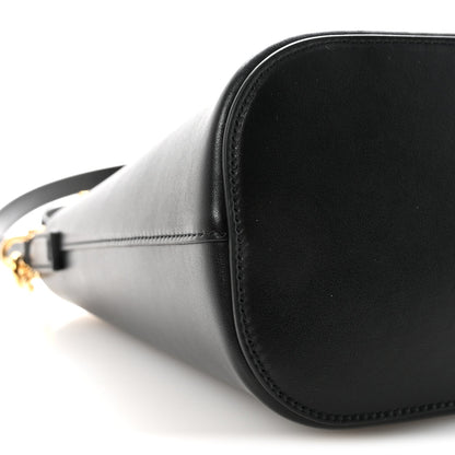 Side view of small black Celine bucket bag with smooth leather and gold hardware