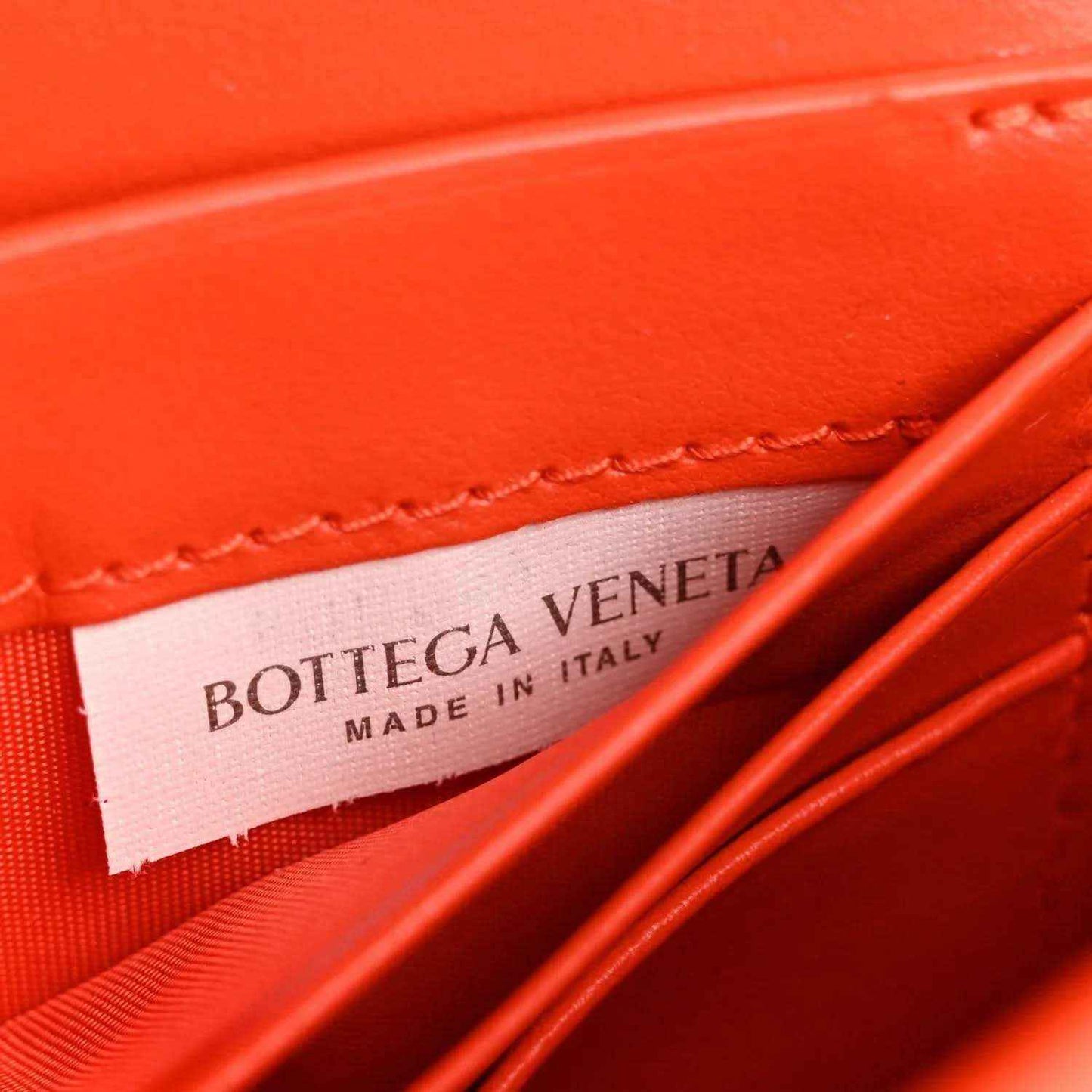 Orange nappa clutch interior with Bottega Veneta made in Italy label