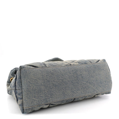 Denim quilted puffer satchel with folded top edge and tan leather base trim