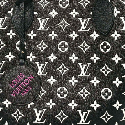 Monogram canvas tote panel with repeating LV motifs and a round branded charm