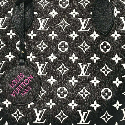 Monogram canvas tote panel with repeating LV motifs and a round branded charm