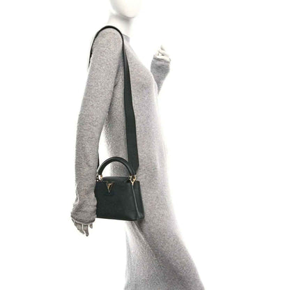 Louis Vuitton black leather mini crossbody bag with adjustable strap, side view