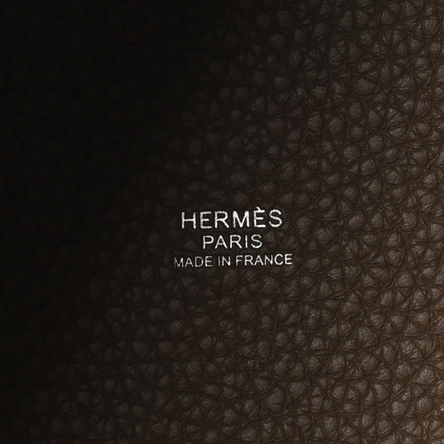 Pebbled leather base with stamped brand text
