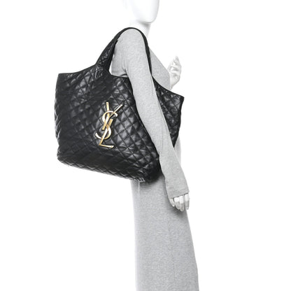 Black quilted leather tote, side view, with YSL logo and top handle