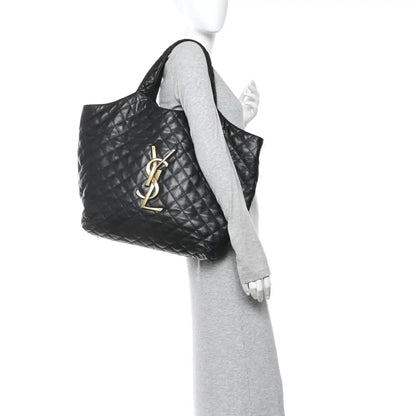 Black quilted leather tote, side view, with YSL logo and top handle