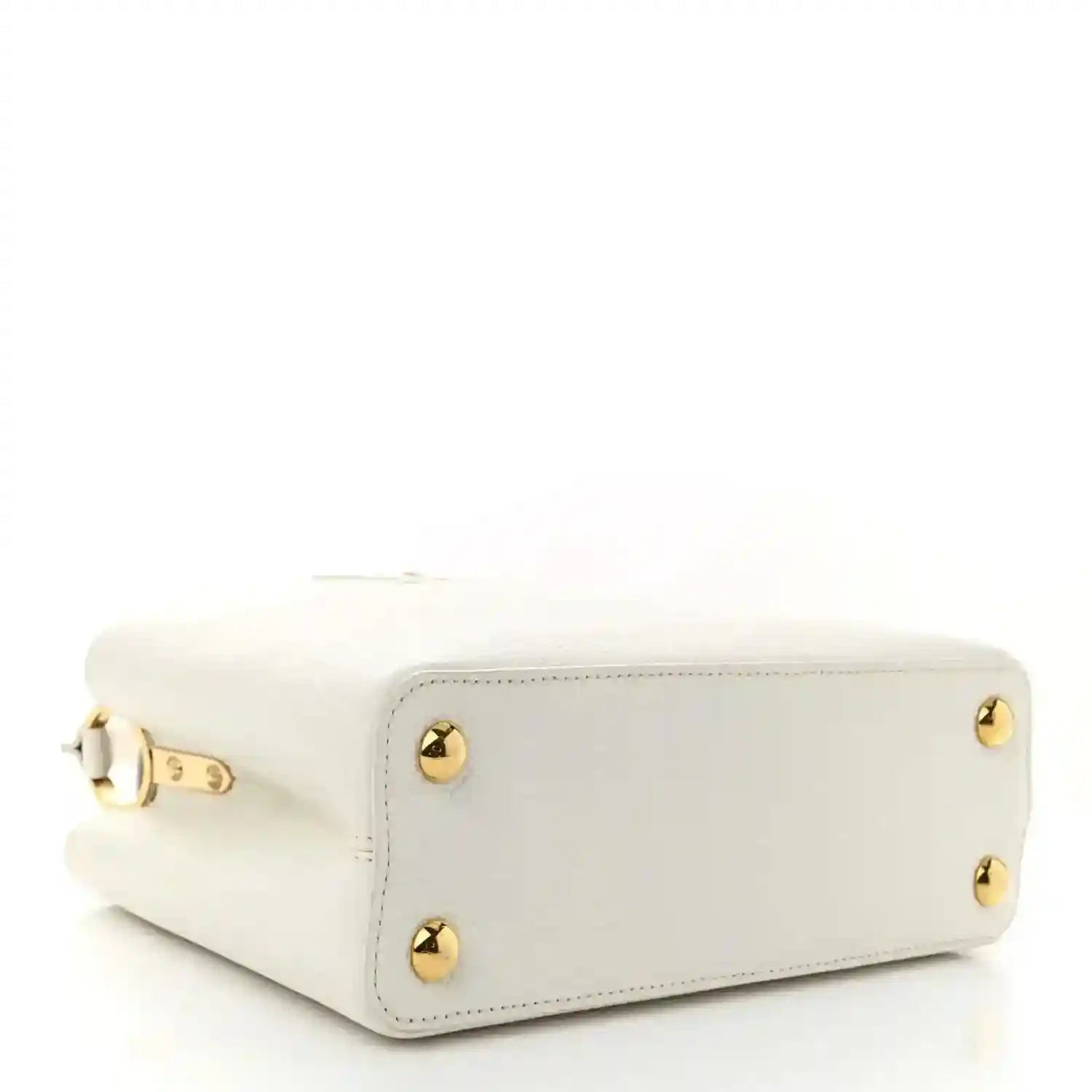 White small top-handle bag with gold corner studs and clasp hardware