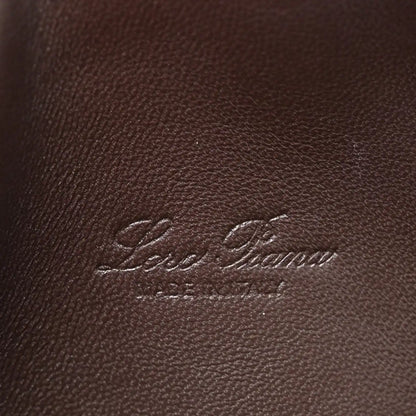 Loro Piana logo embossed on dark brown lizard leather pouch surface