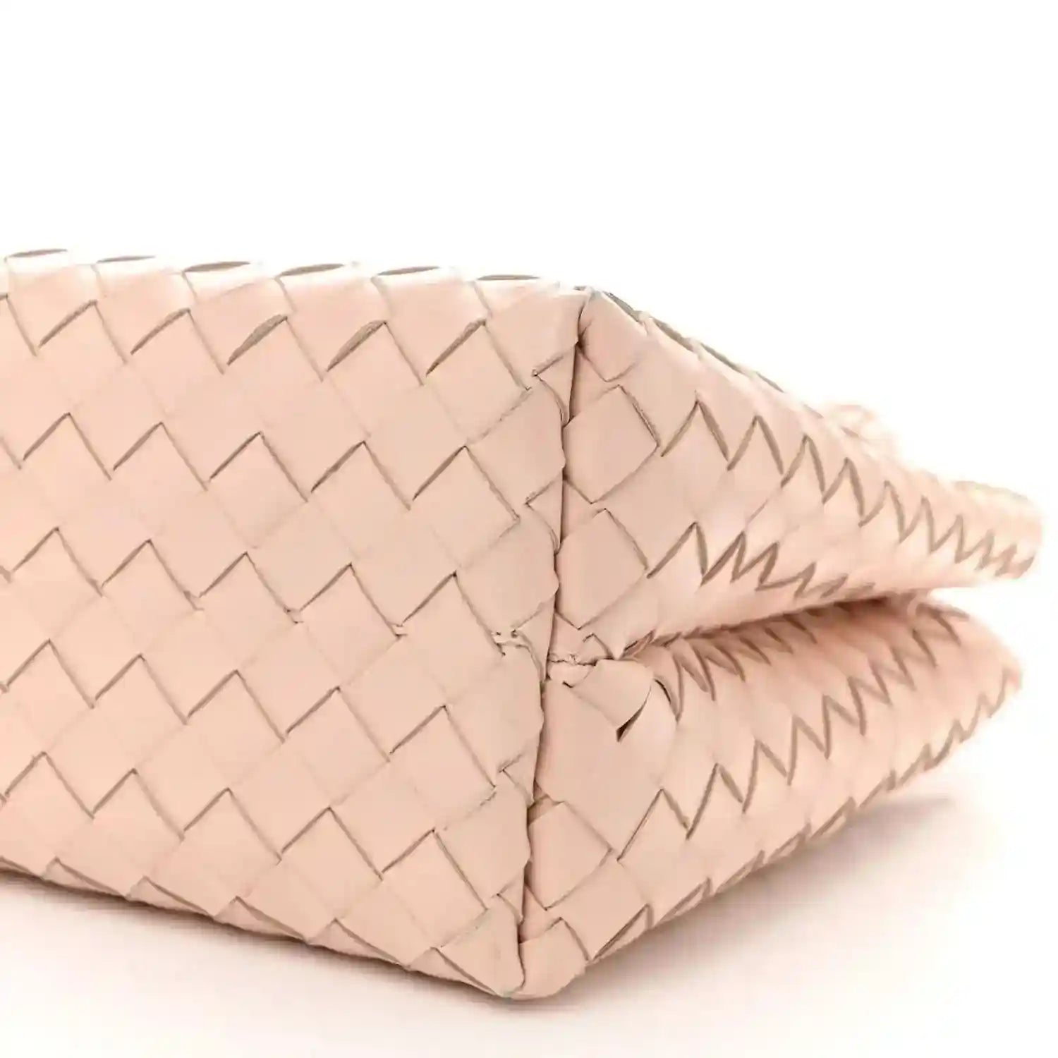 Pink intrecciato leather medium tote bag with side panel and bottom edge close-up