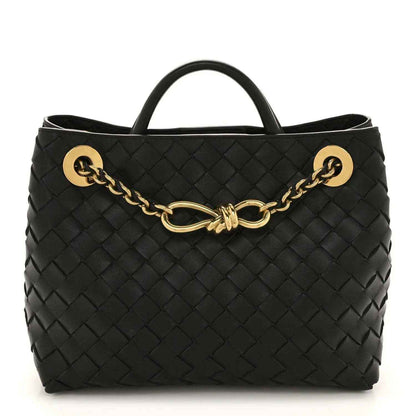 Black woven leather chain shoulder bag with top handle and gold-tone clasp hardware