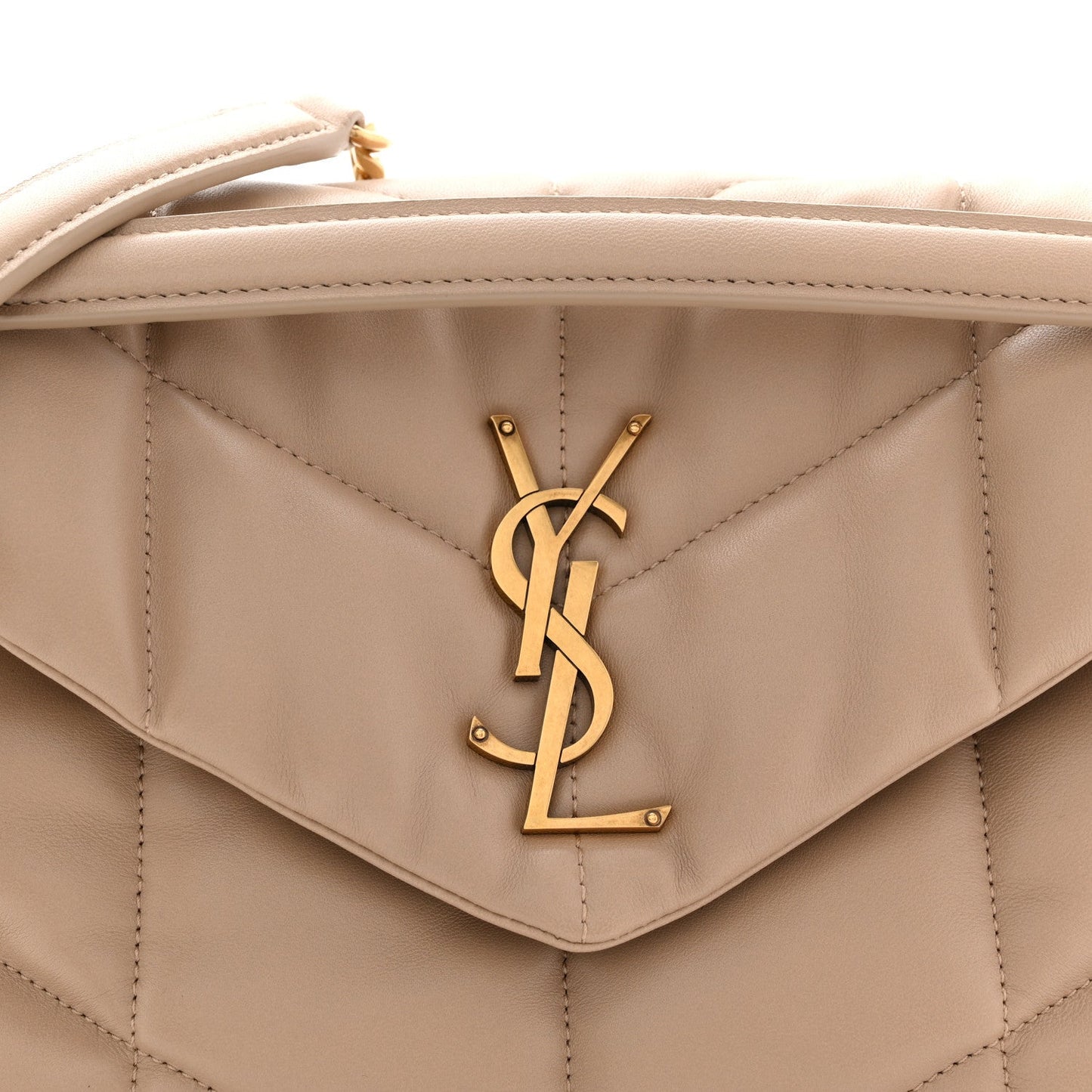 Saint Laurent quilted flap satchel detail with YSL monogram clasp, dark beige