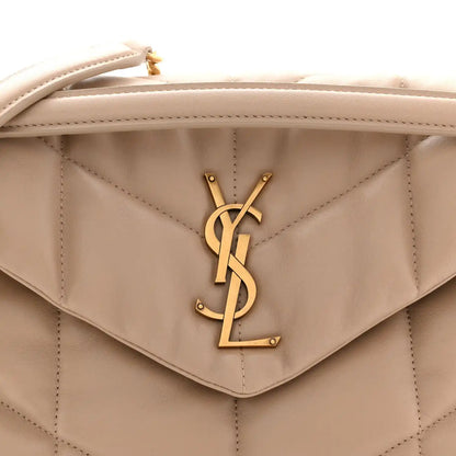 Saint Laurent quilted flap satchel detail with YSL monogram clasp, dark beige