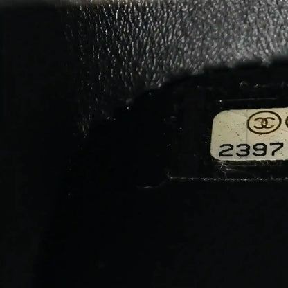 Black bag serial stamp with Chanel emblem and number 2397.