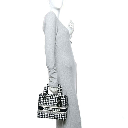 Black-and-white houndstooth canvas bag with short strap and Dior logo band