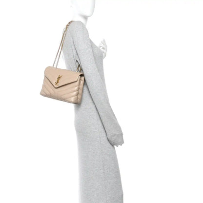 Small dark beige quilted chain satchel worn crossbody by model