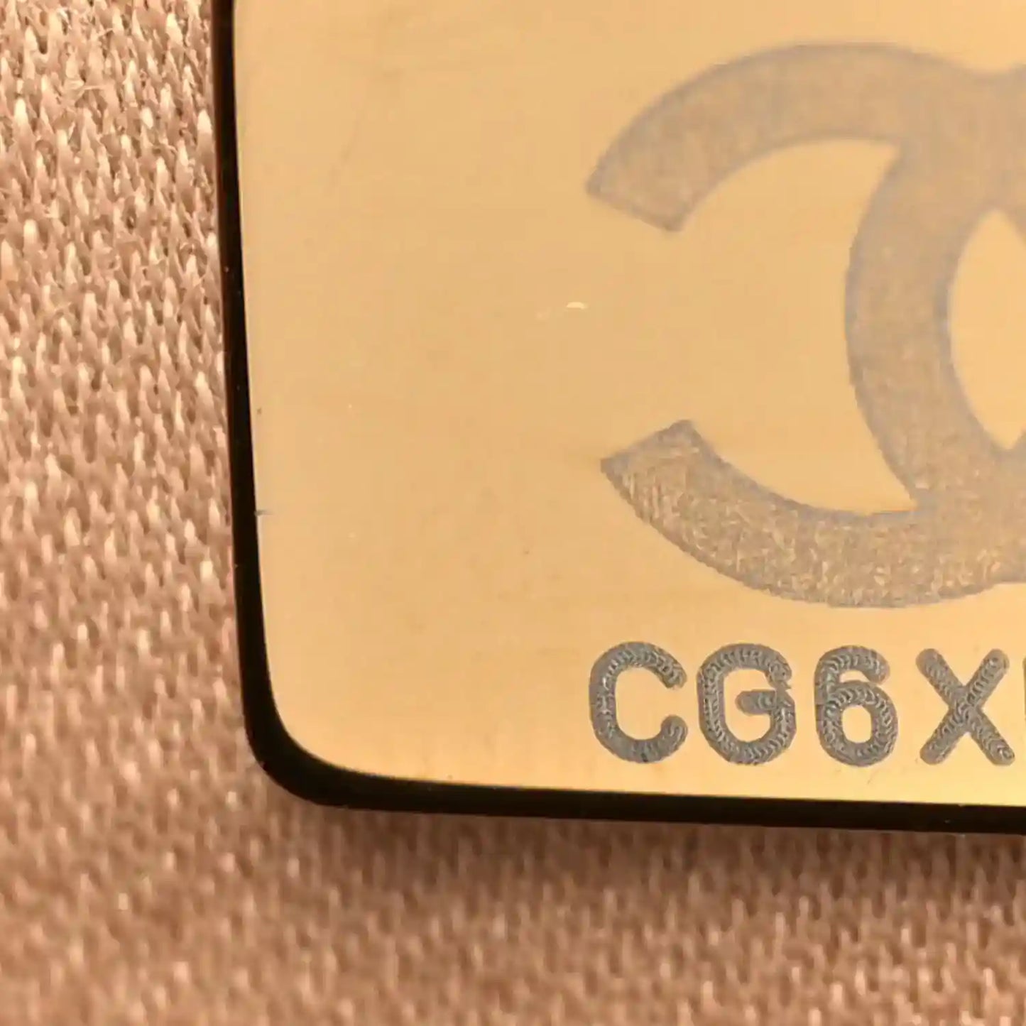 Chanel code stamp on beige fabric backing with raised lettering