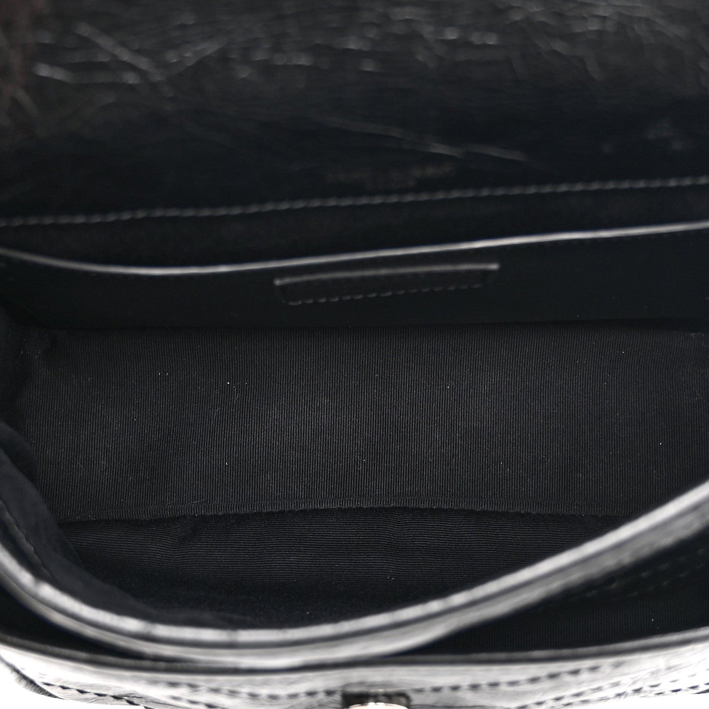 Black satchel interior with fabric lining and stitched edge detail