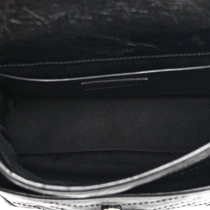Black satchel interior with fabric lining and stitched edge detail