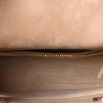 Beige handbag interior with zippered top opening and stitched edge