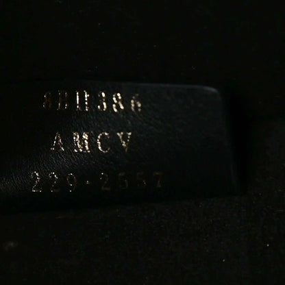 Black leather tote bag label with FENDI and Made in Italy text