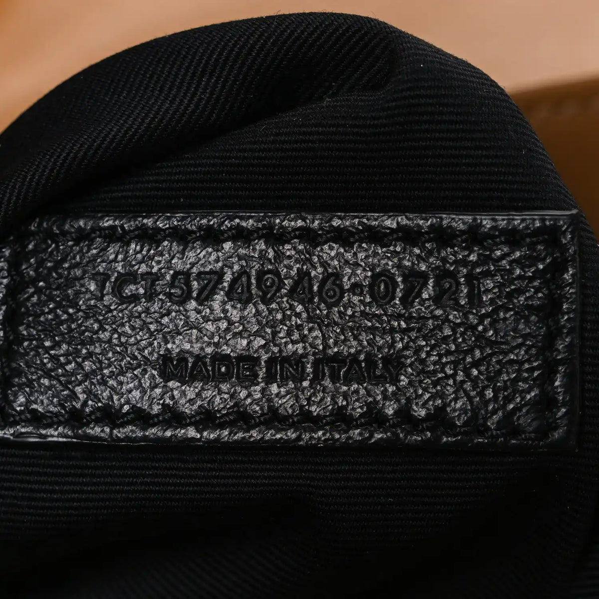 Black fabric interior stamp with code and “MADE IN ITALY” text