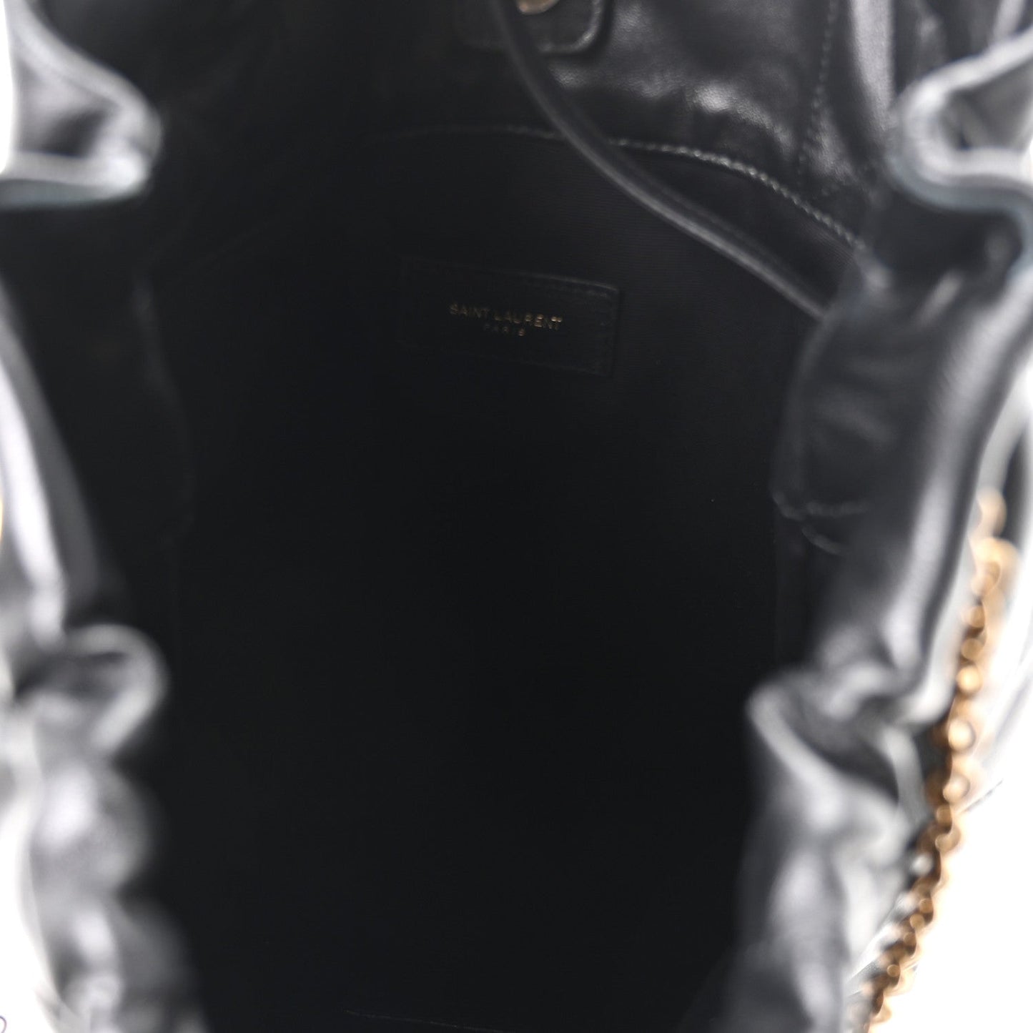 Black leather interior panel with embossed Saint Laurent logo